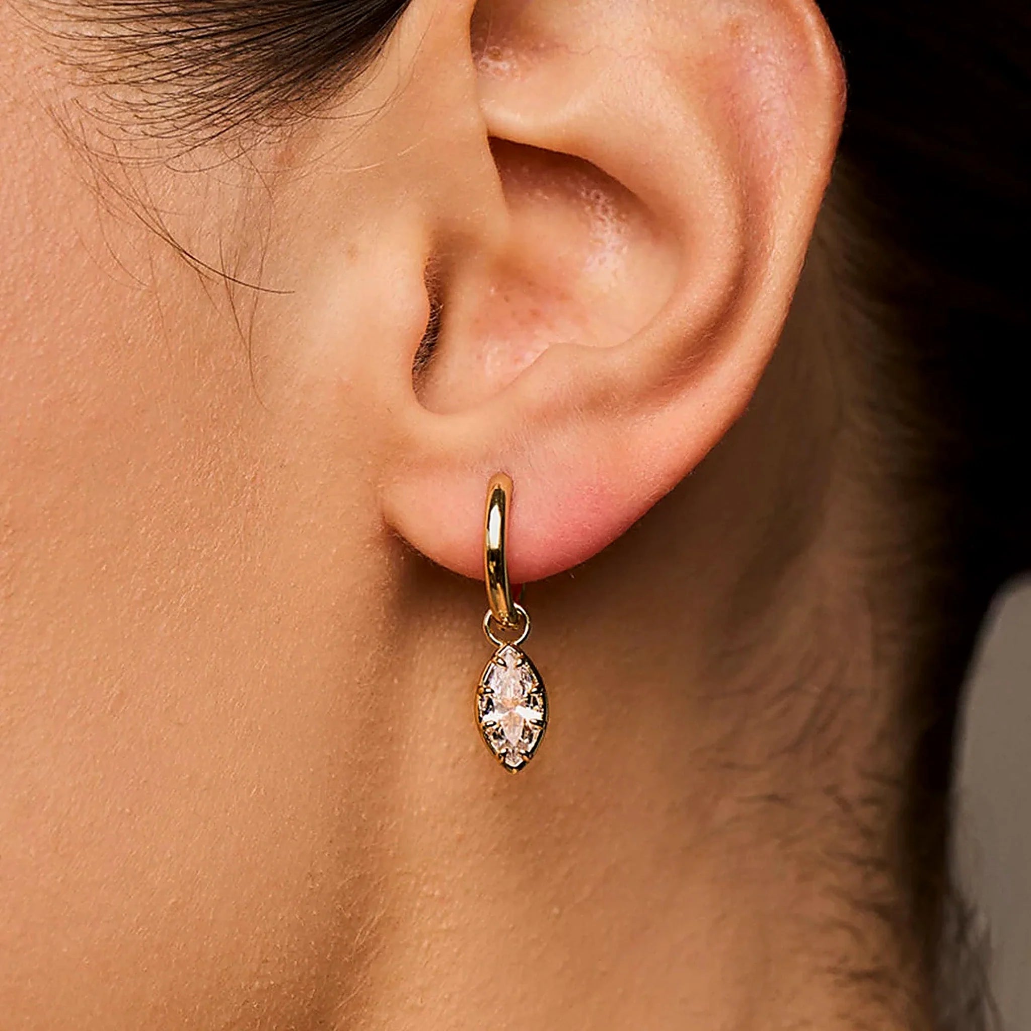 Aveline Marquise Drop Huggie Earring worn in a close-up jewellery care view