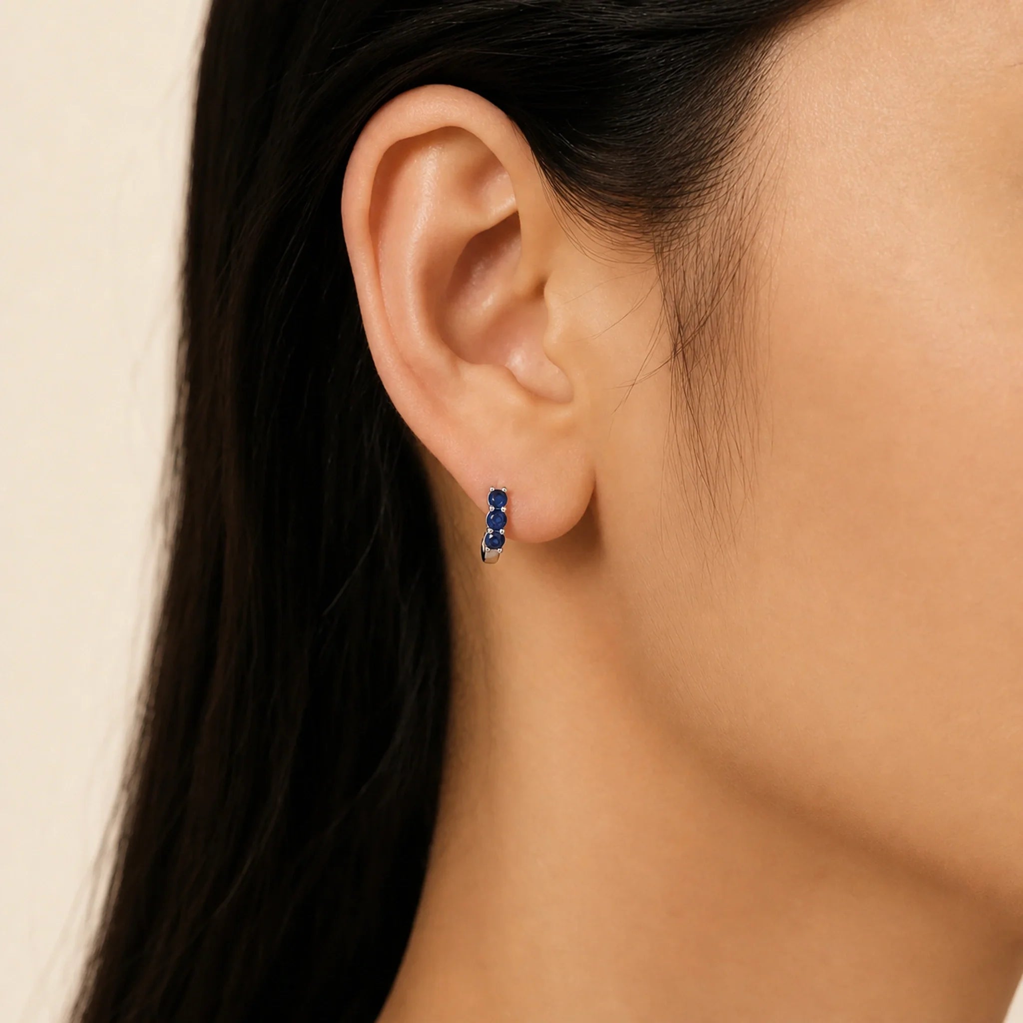 Celeste Blue Zircon Huggie Earrings worn, illustrating sterling silver jewellery