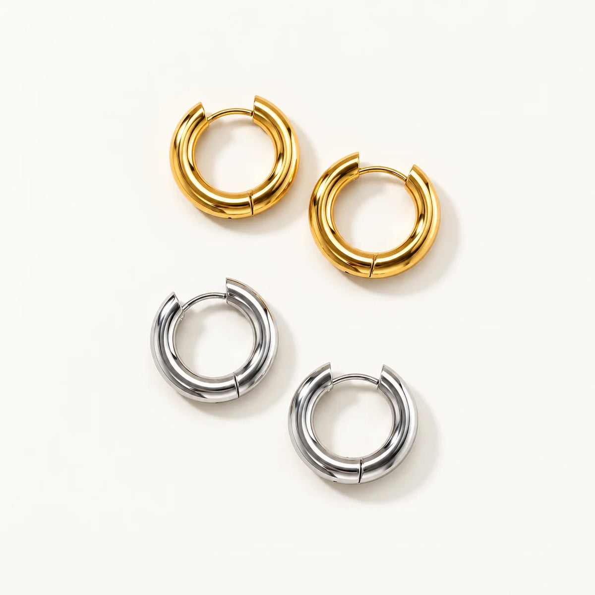 Nico round huggie earrings in gold and silver tones