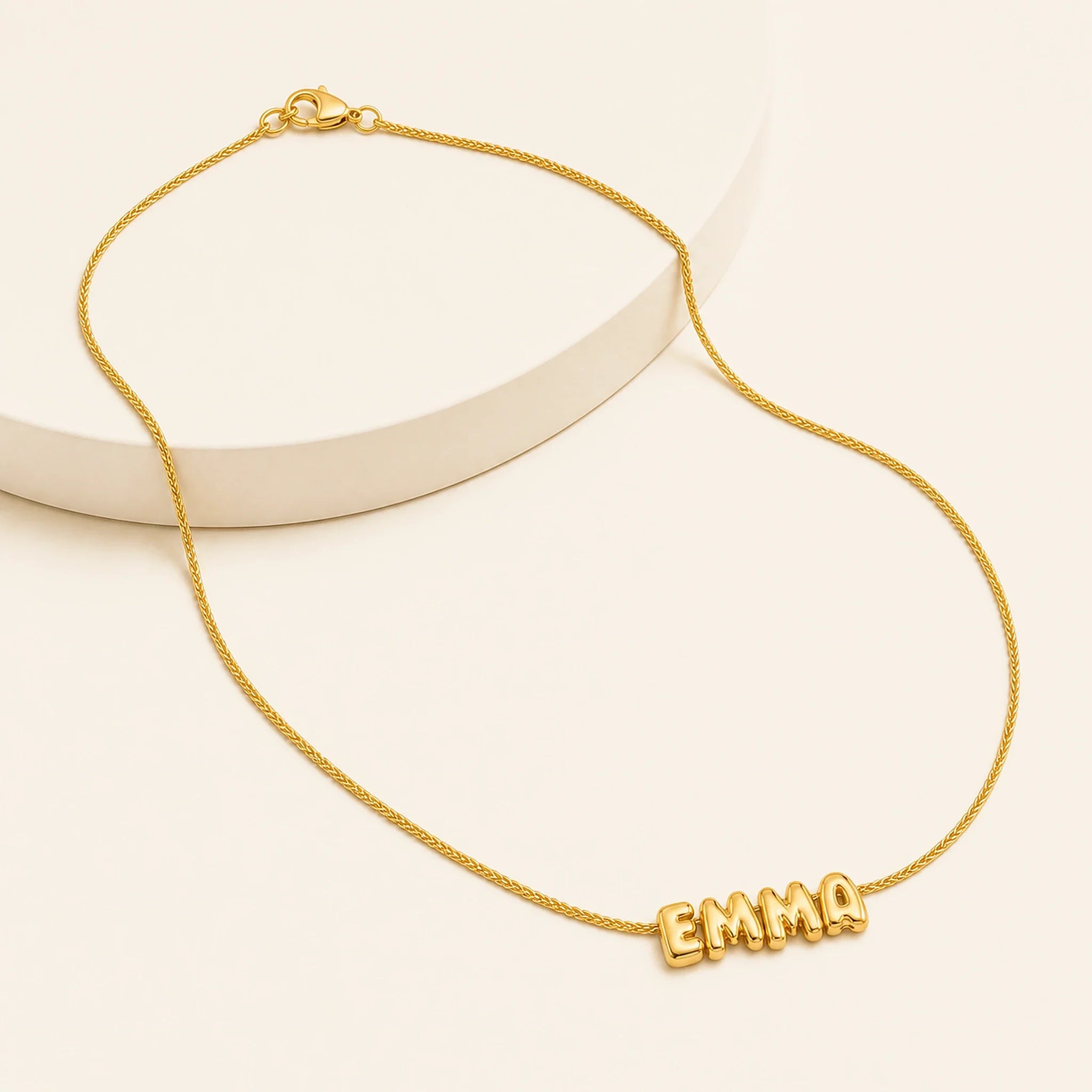 Aria Bubble Name Necklace arranged in gift-ready presentation