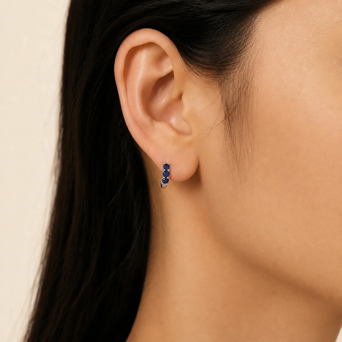 Celeste Blue Zircon Huggie Earrings worn, illustrating sterling silver jewellery