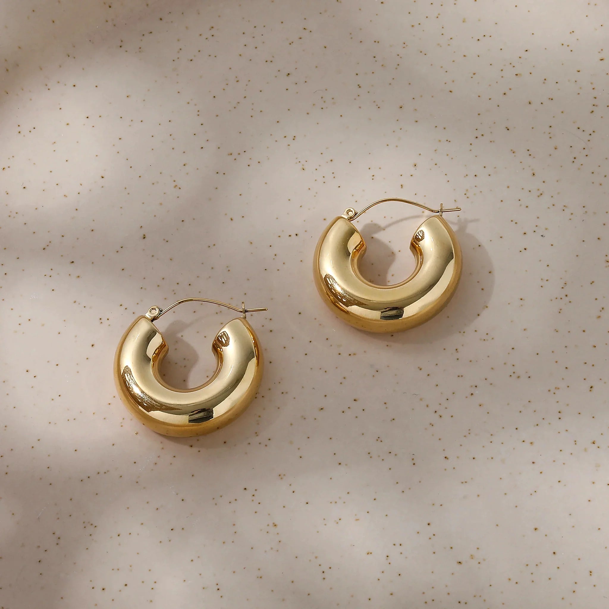 Orla Sculpted Double Hoop Earrings worn close to the earlobe